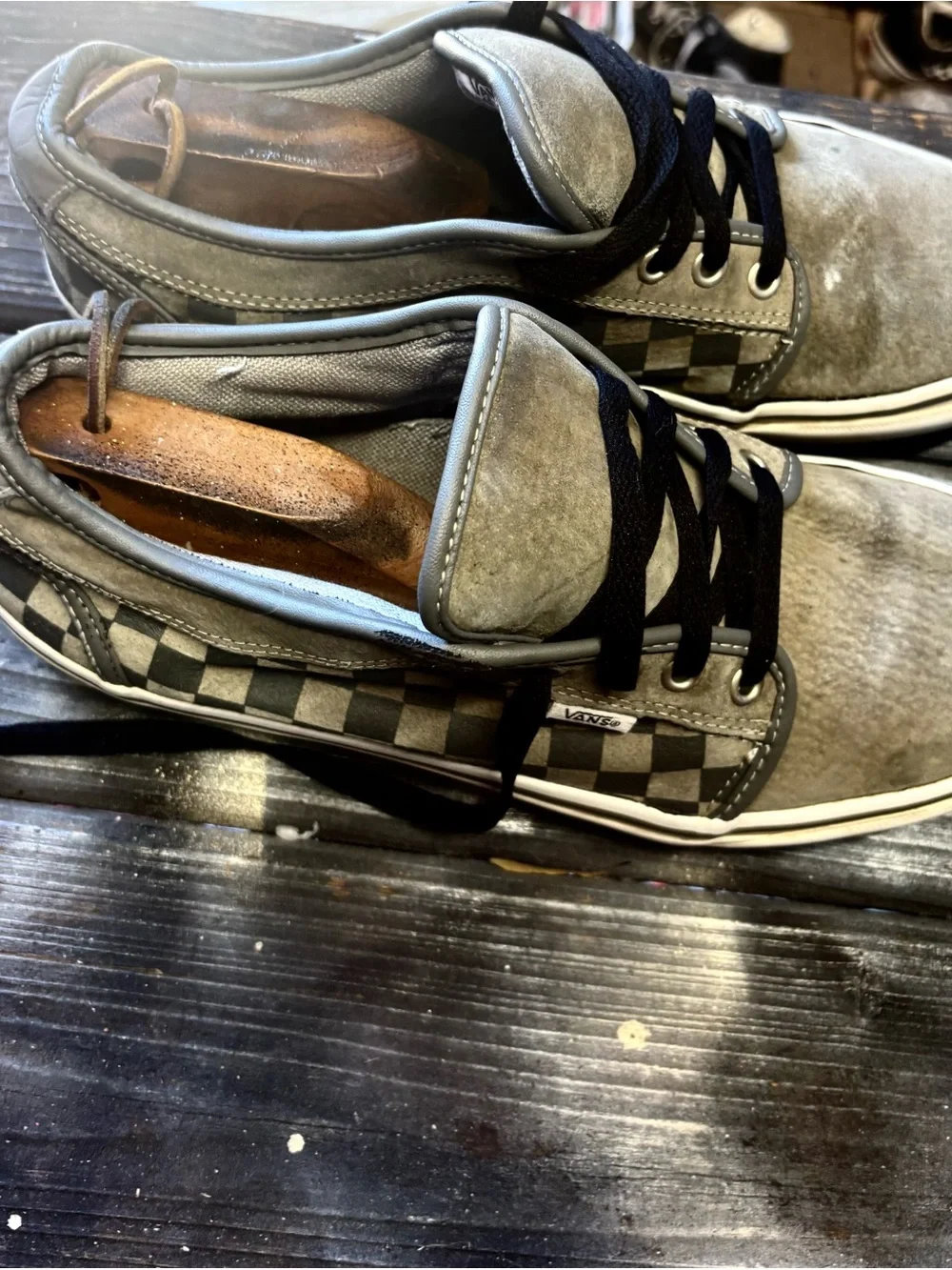 Vans gray suede sneakers with black & white checkerboard pattern on the side